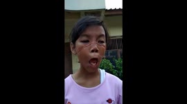 Girl pulls funny faces during 'rubber band' competition