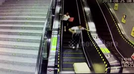 Suitcase tumbles down escalator and wipes out commuters
