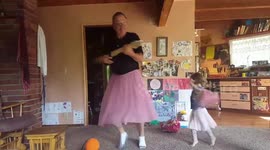Grandpa dons pink tutu to play guitar and dance with granddaughter