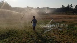 Soaked 4-Year-Old Kid Runs Through Sprinkler