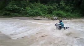 Moment man on motorbike is swept away in northern India floods