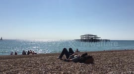 Summer’s back! Hordes gather on Brighton beach