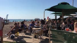 Summer’s back! Hordes gather on Brighton beach