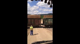 Waiting (nearly) all day for a very long train to pass at a level crossing in Romania