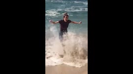 Woman caught by wave