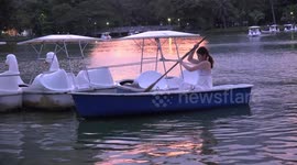 Lady in a boat at sunset.