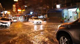 Vehicles battle through flooded roads after downpours in Thailand coastal city