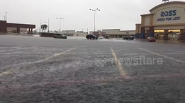 Heavy downpour floods parking lot in Galveston, Texas