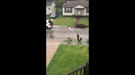 Surf's up! Neighbors take to flooded street on surfboard in Galveston, Texas
