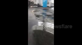 Rainwater seeps through terminal walls of Chicago airport as torrential rain hits city
