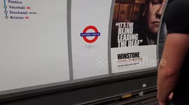 Sassy tube worker coaches passengers onto train