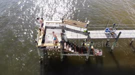 boys do flips off pier