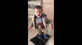 Cute toddler dancing on laptop