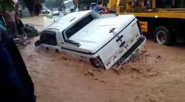 The moment of rescue the pickup truck washed away by the flood