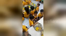 Heartwarming moment big sister feeds little brother on first day at school