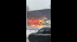 Police car on fire on the M62 after towing stranded wagons in the snow