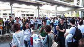 Thousands of stranded passengers and airport employees queue for shuttle services out of Kansai Airport island