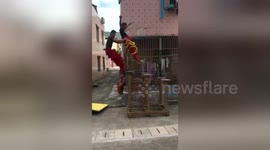 Apprentice duo hone traditional Chinese lion dance with spectacular 'backwards leaps'