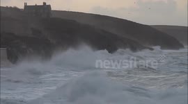 Huge waves in Cornwall as storms batter the UK