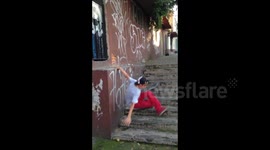 Skateboarder face-plants the pavement