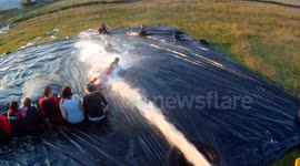 Extreme Slip'N'Slide ALS challenge using a tractor, By Young Farmers in the Orkney Islands, Scotland, UK