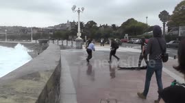 Huge wave knocks man to the ground in San Sebastian, Spain