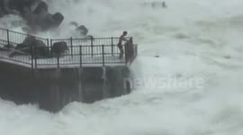Teenagers risk lives in typhoon waves in Okinawa, Japan