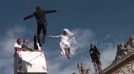 Tightrope walkers re-enact famous wedding photo