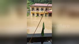 Pupils stranded in submerged school amid flooding in Vietnam