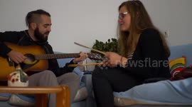 Girl and guy playing music together
