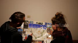 Guy is giving directions to a girl on a map