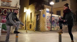Girl and guy balancing on two poles_2