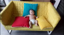 Baby relaxing on a sofa like a BABY BOSS