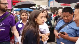 Alexandria Ocasio-Cortez shakes hands at Queens rally
