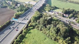 Drone view of M25 Motorway Traffic Train Boats Vehicles Countryside Kings Langley Junction 20