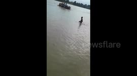 Shocking moment boat with 29 passengers sinks in flooded river