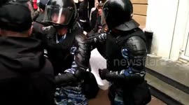 Russian couple is arrested by riot police during rally against pension reform plan
