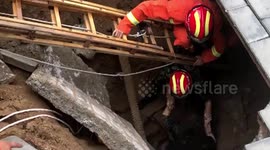 Firefighters rescue woman trapped in sinkhole