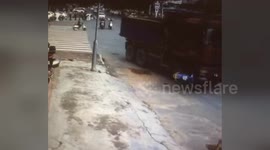 Scooter driver narrowly escapes being run over by truck