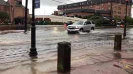 Cars drive through flooded Annapolis streets as river overflows