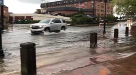 Cars drive through flooded Annapolis streets as river overflows