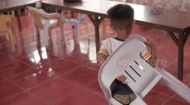 Schoolboy re-lives moment he put plastic chair on his back like a rucksack