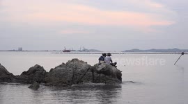 Fishing from a rock.