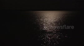Moonlight dancing on a lake.