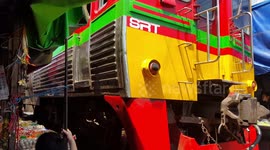 Incredibly close shave as train skims past market stalls