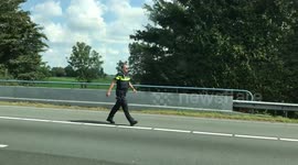 Impatient drivers block an ambulance while driving the wrong way on a highway in the Netherlands