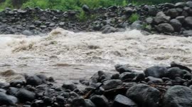Stream breaks its banks and overflows as Tropical Storm Olivia brings downpour to Big Island