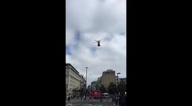 Helicopter ambulance lands on street in London rush hour