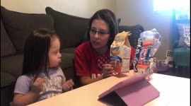 Non-verbal toddler using speech tablet for the first time.