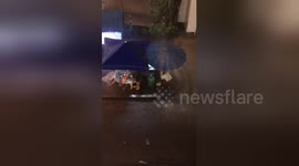 Newsflare Edit - Street food seller picked the wrong spot... under a 'waterfall'